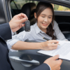 Woman in car signing a contract